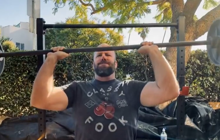 Image of Chris Sullivan lifting weights to stay fit